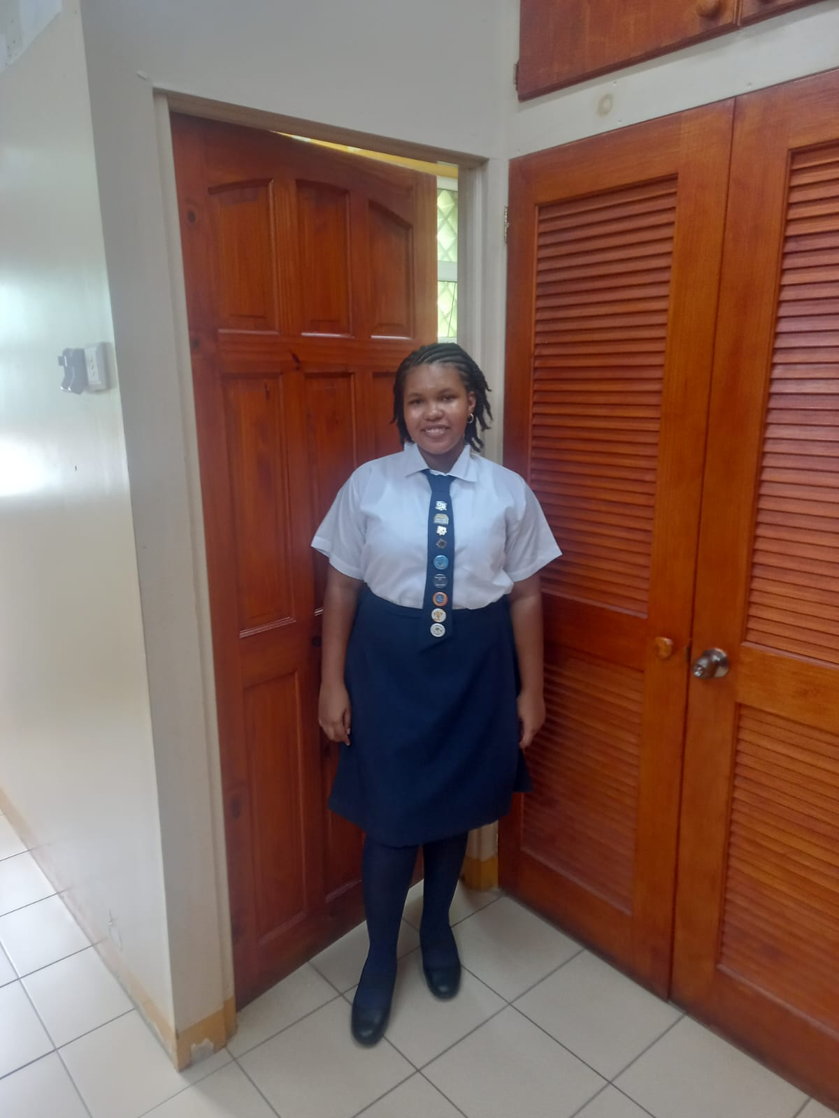 Portrait of Amina, a 14 year old girl from Dominica smiling