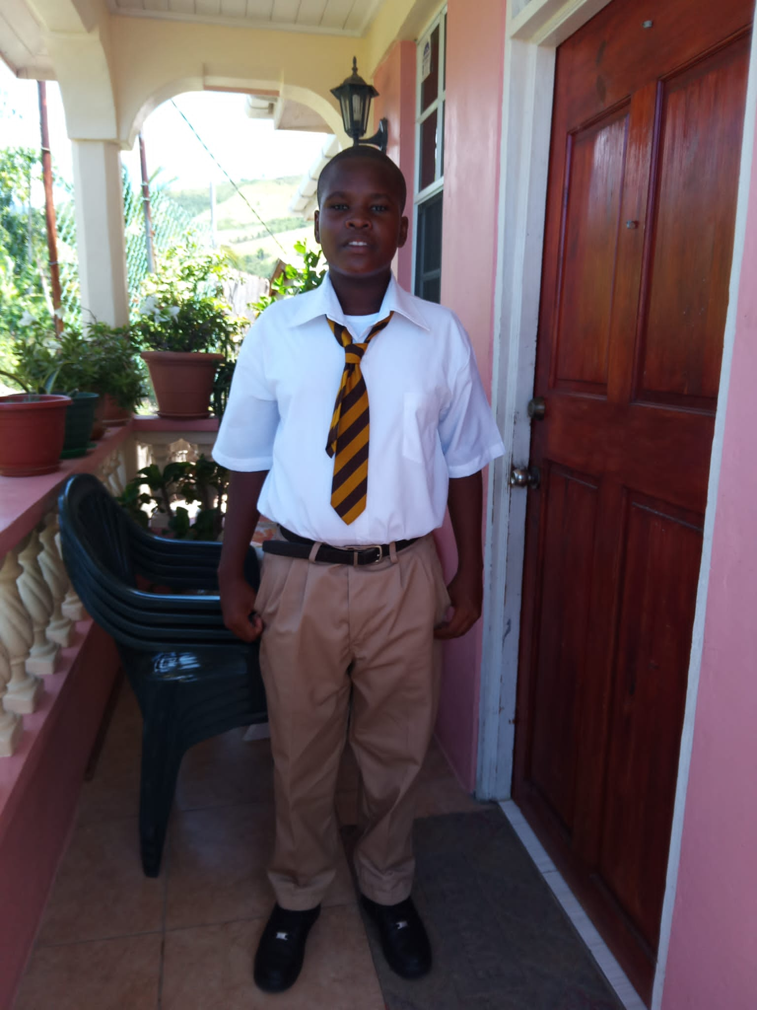 Portrait of Leah, a 12 year old girl from Dominica smiling
